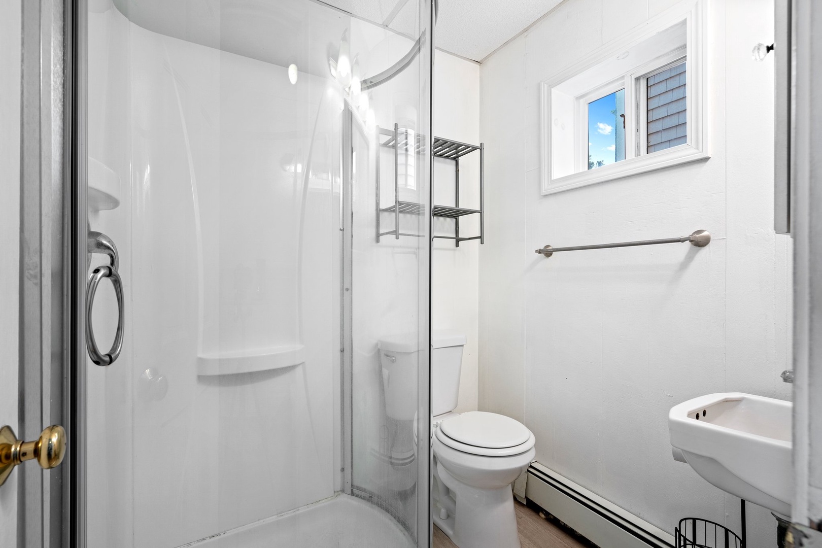 Wash up in the full bath, featuring a pedestal sink & shower