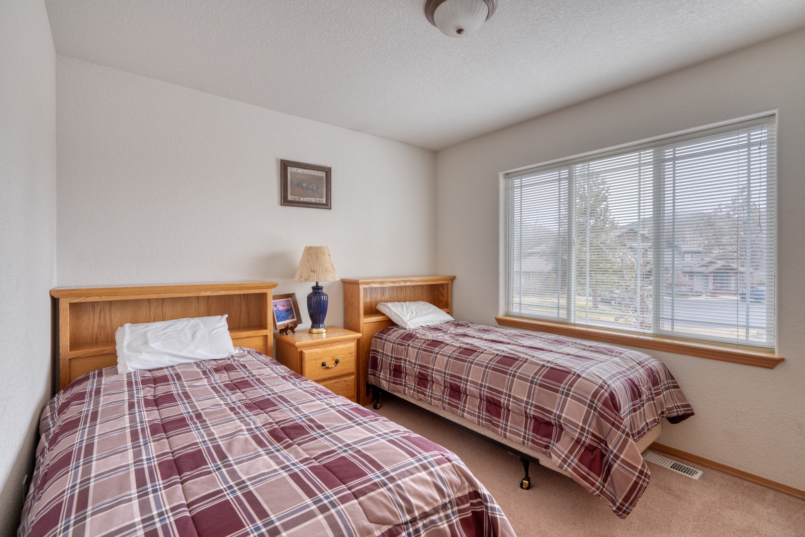 A pair of plush twin beds awaits in this second-floor bedroom