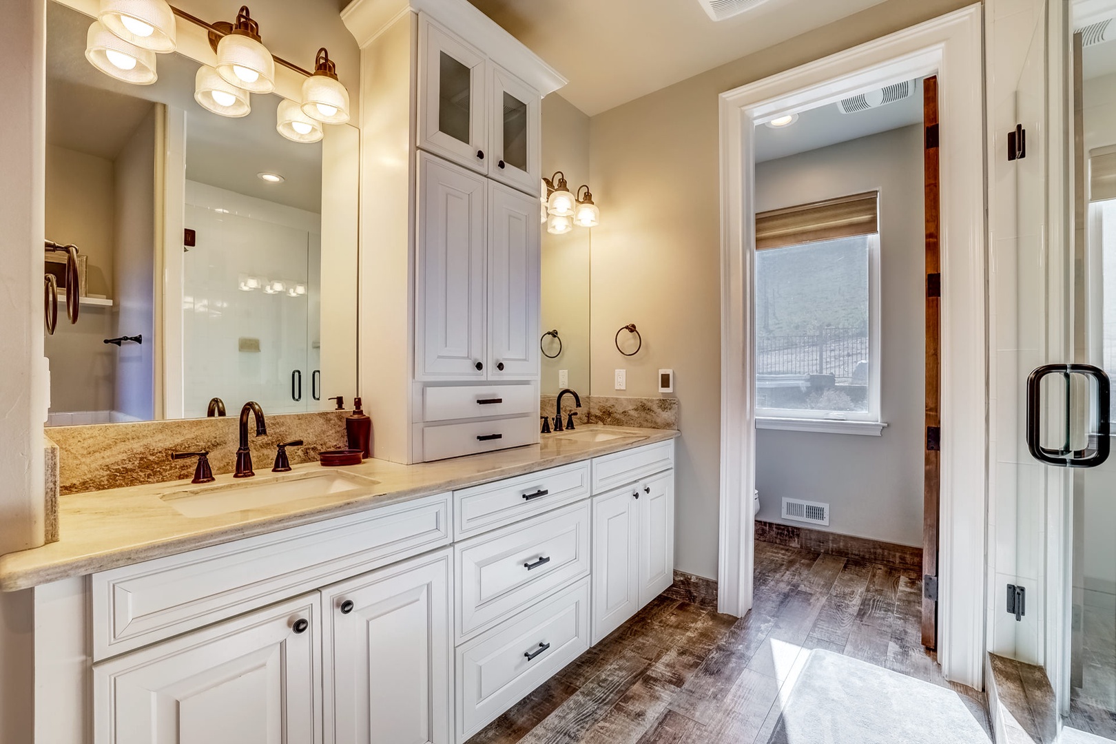 En-suite Master bathroom with dual sinks, walk-in shower, and soaking tub