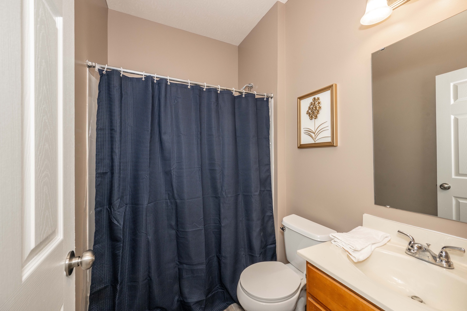 Wash up in this full bath on the main level, offering a shower/tub combo