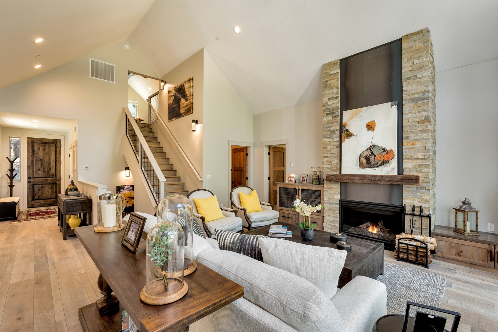 Living room with floor to ceiling windows, gas fireplace, and comfortable seating