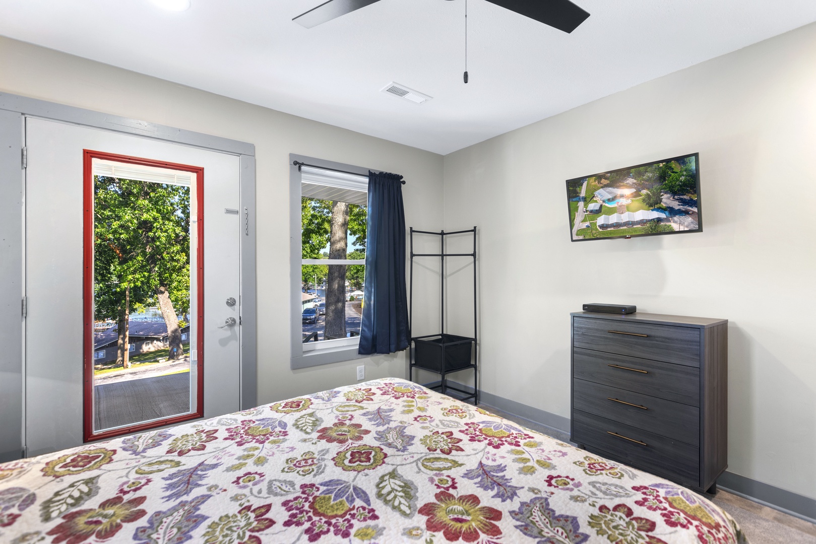 Bedroom 1 with queen bed, Smart TV, and patio access