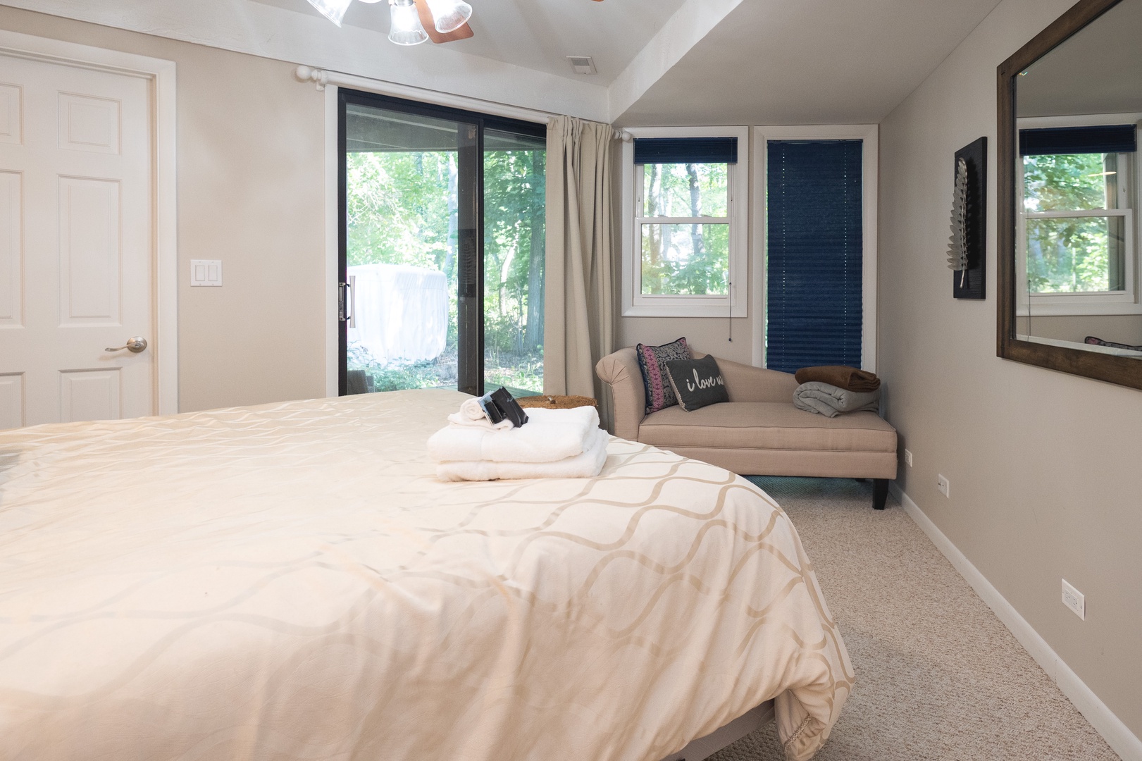 The master bedroom offers a king bed, sitting area, & deck access