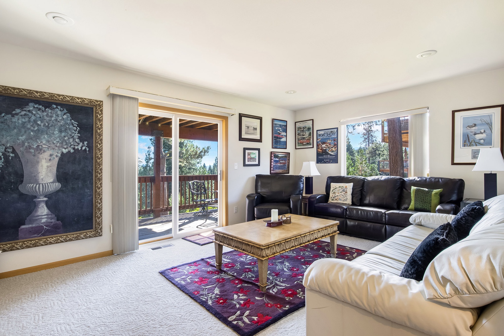 Additional living area on the bottom floor with balcony, seating, and TV