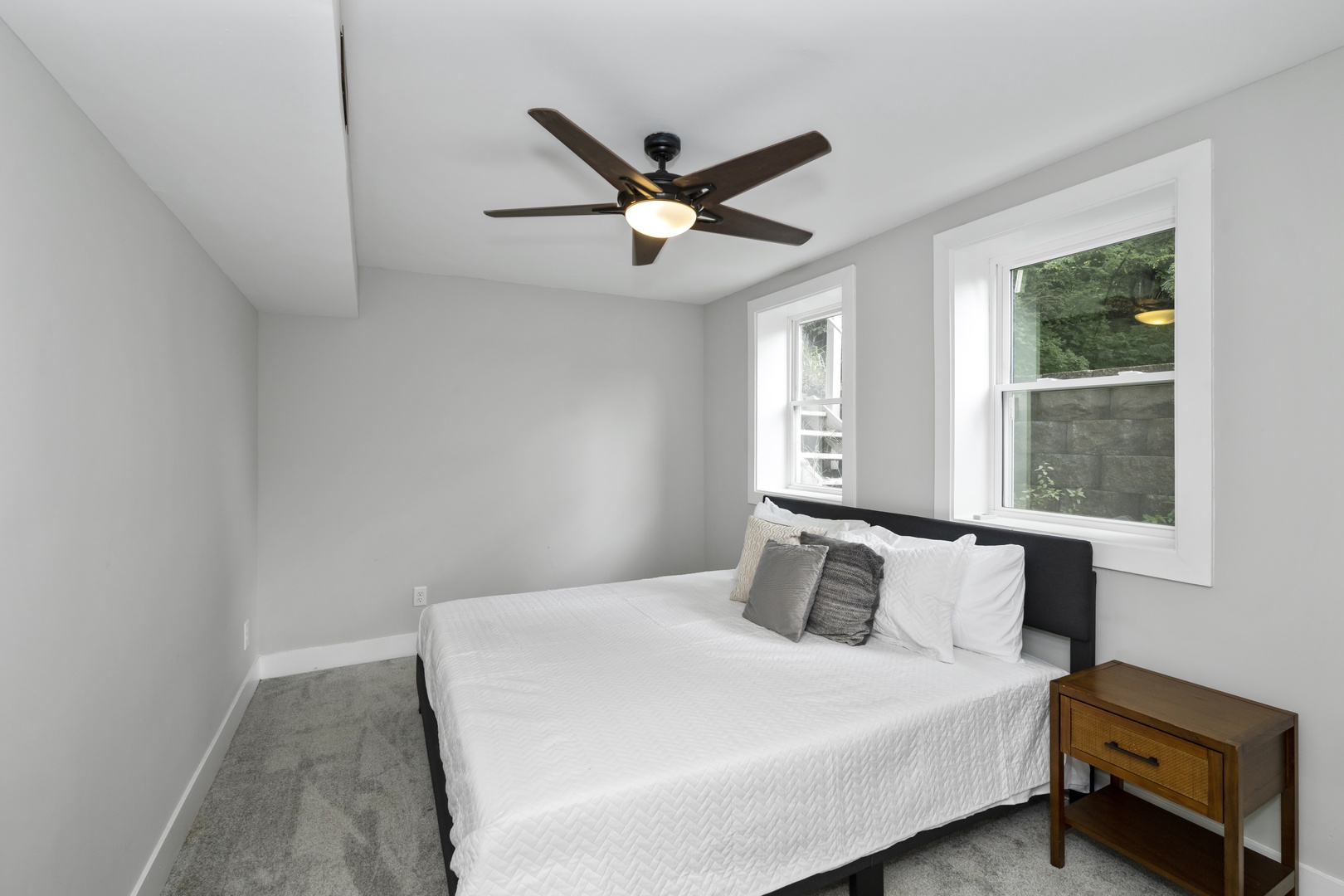 The lower-level king bedroom offers a ceiling fan & lots of privacy