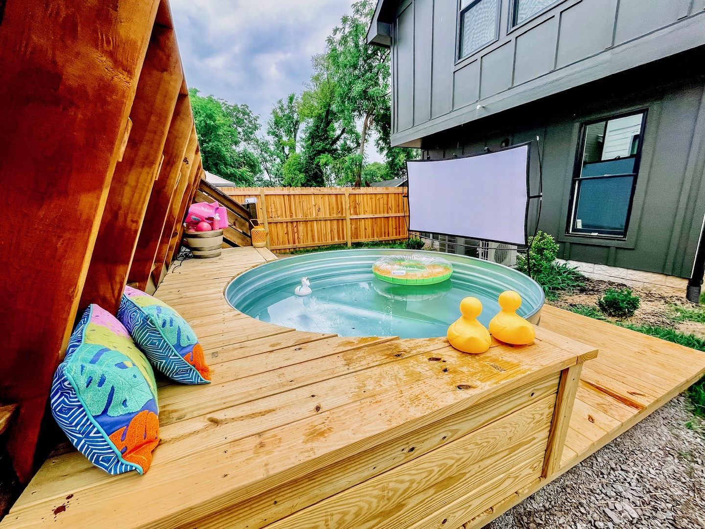 Enjoy an outdoor, floating movie night in the stock tank pool!