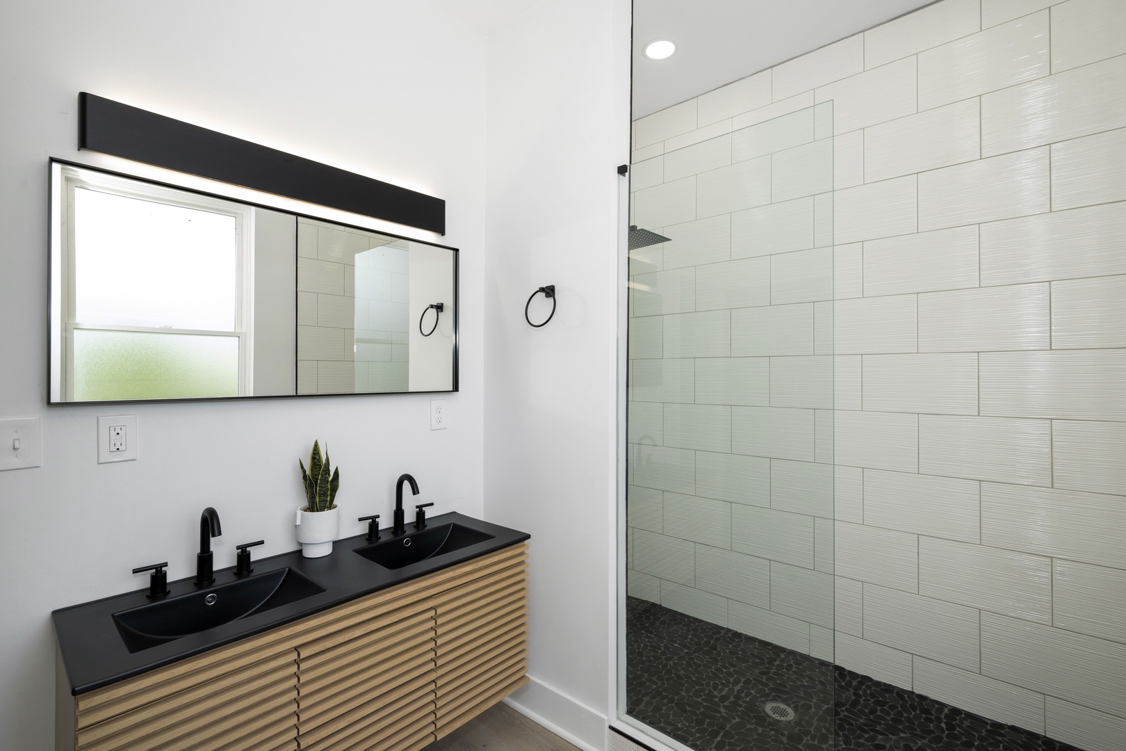 The king ensuite offers a sleek double vanity & luxurious glass shower