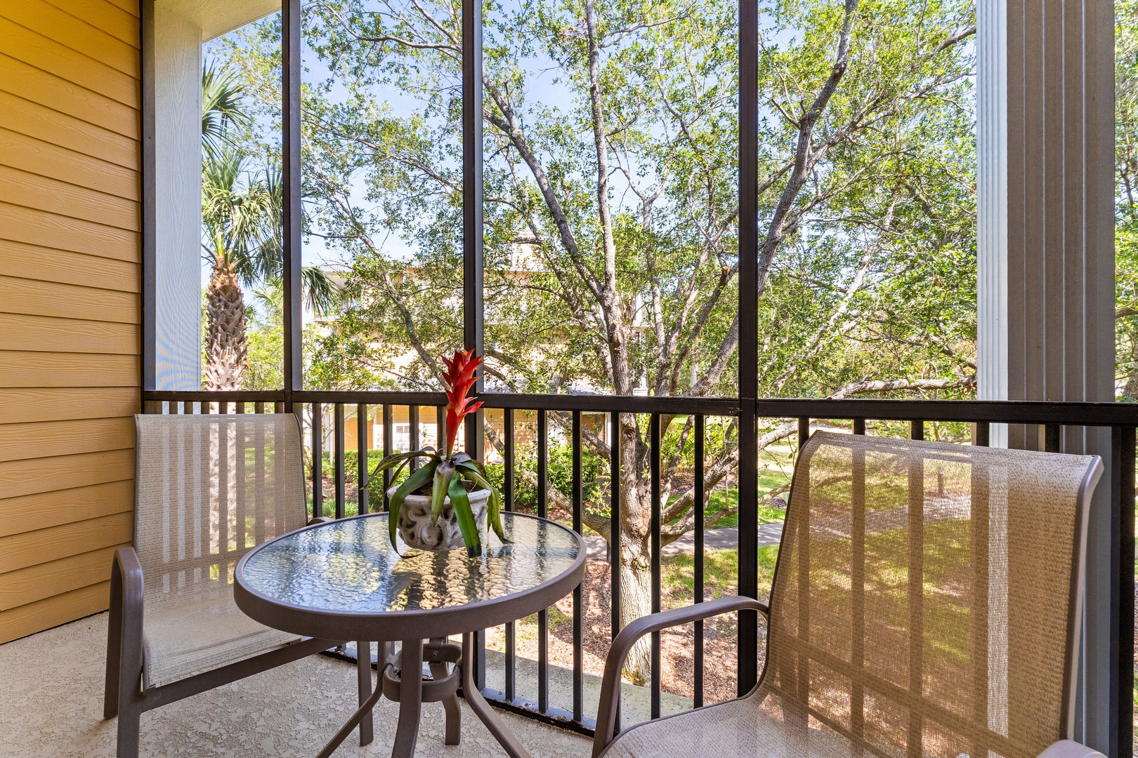 Screened balcony with two chairs, perfect for relaxing & enjoying the fresh air