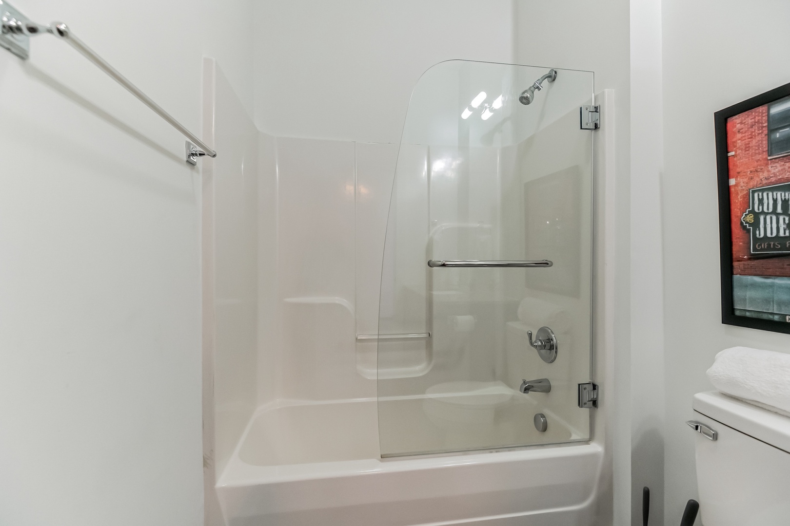 The sleek full bath includes a single vanity & shower/tub combo