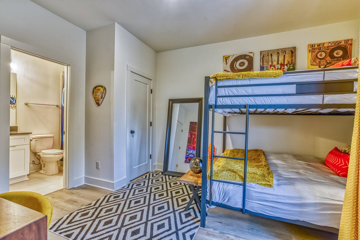 This 1st-floor bedroom includes queen-over-queen bunks & a private en suite