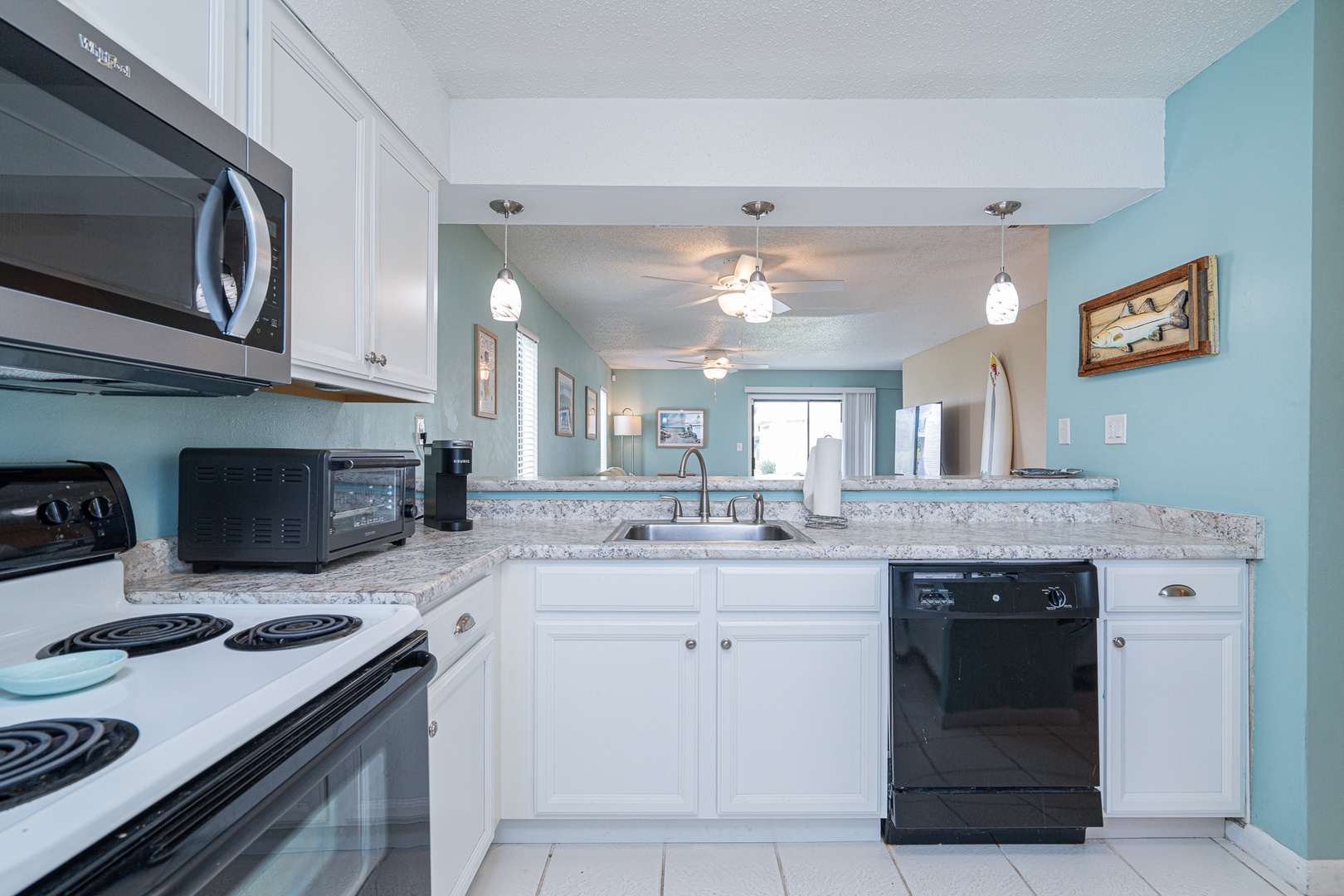 The open, breezy kitchen offers ample space & all the comforts of home