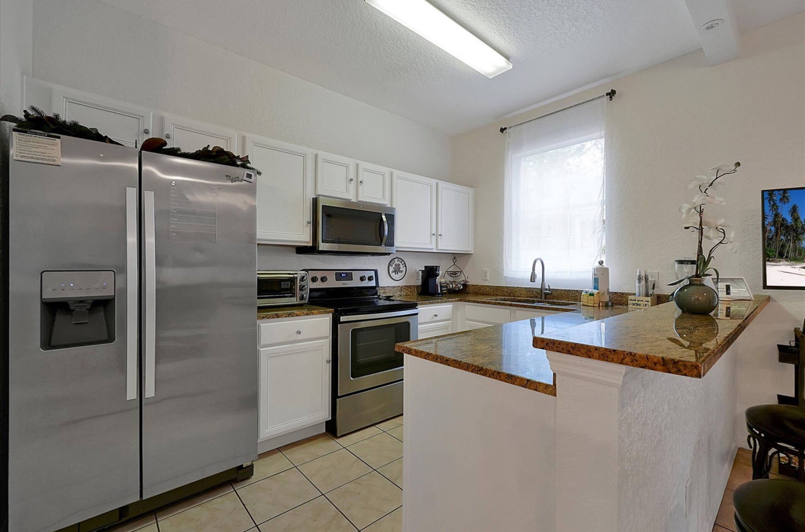 The open, airy kitchen offers ample space & all the comforts of home