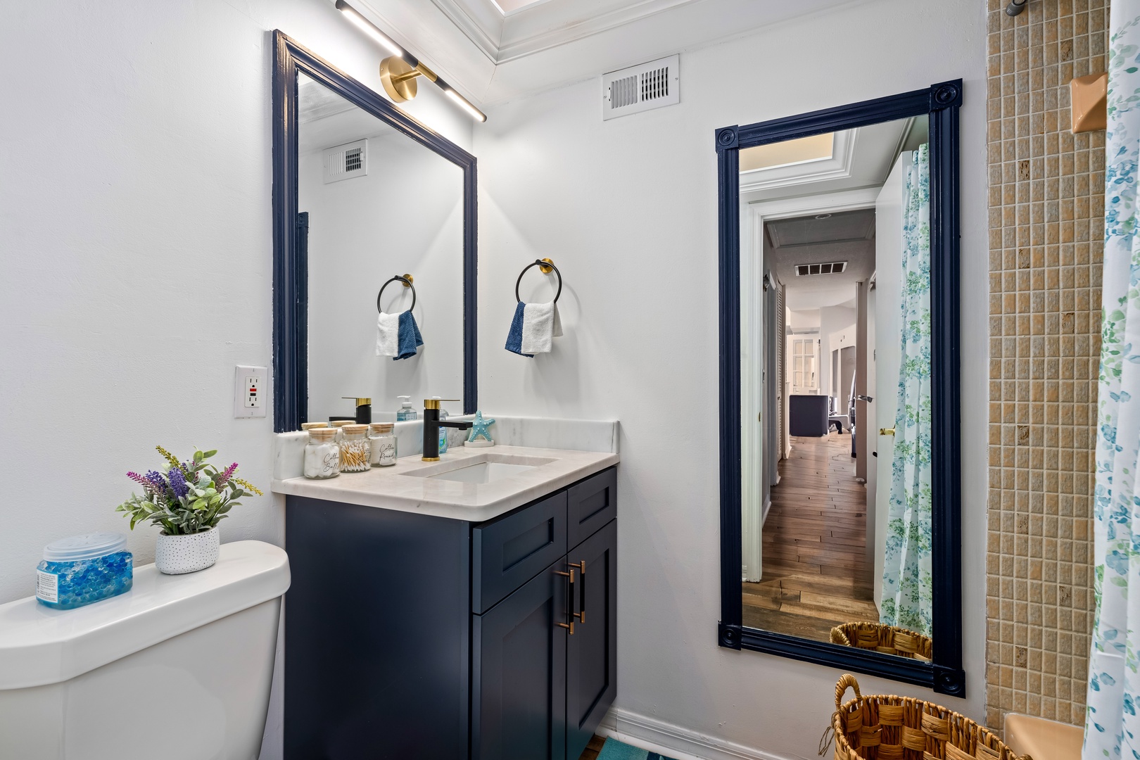 Elegance abounds in the hall bath, with a single vanity & shower/tub combo