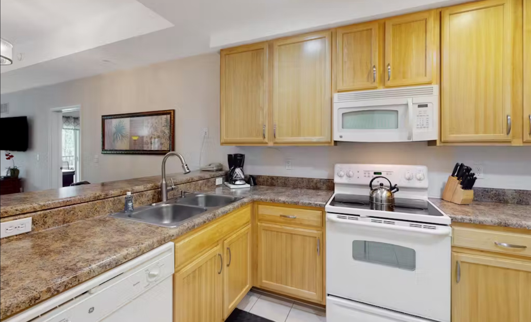 The cozy kitchen offers ample space & all the comforts of home