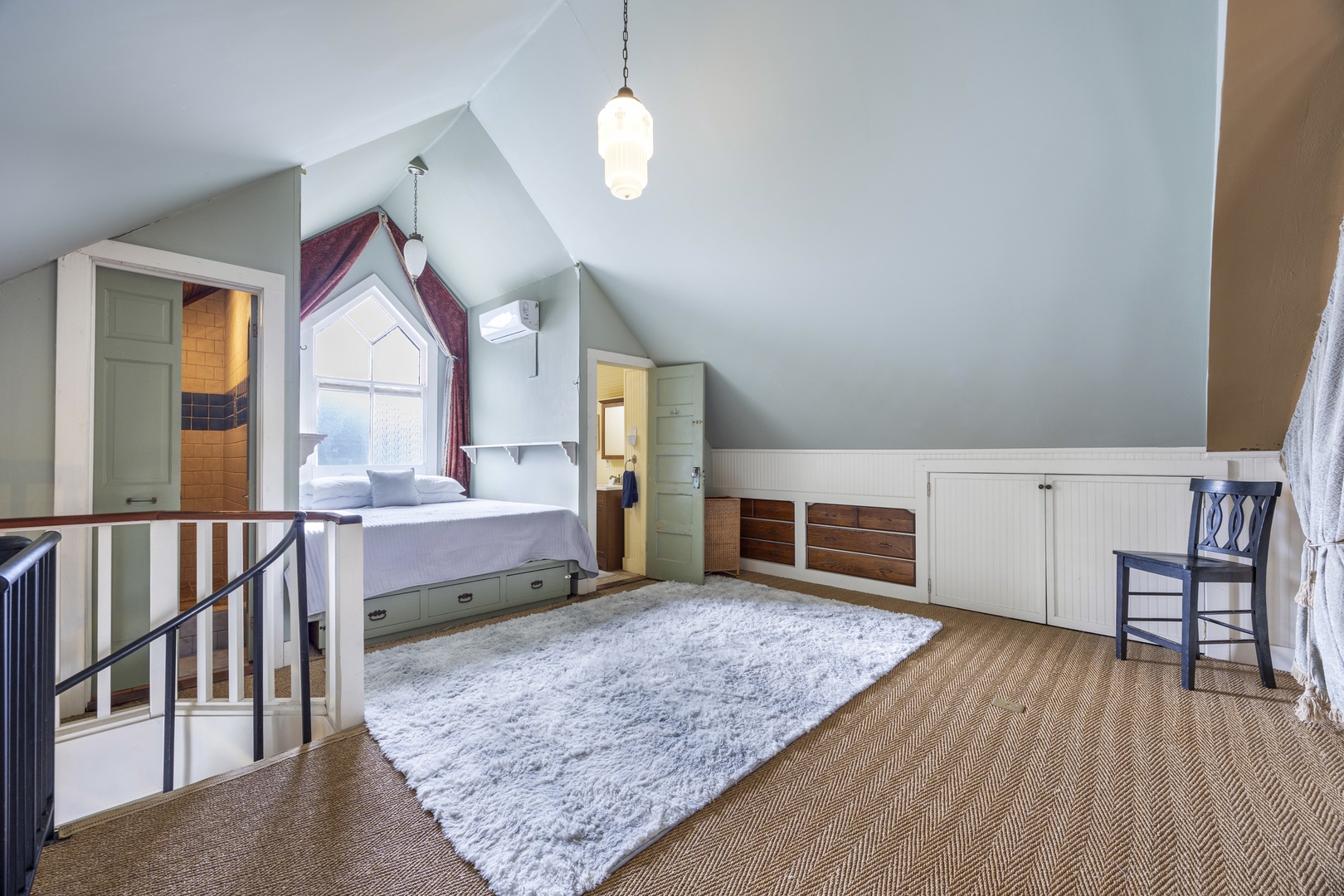 Recharge in the loft sleeping area, boasting a plush queen-sized bed