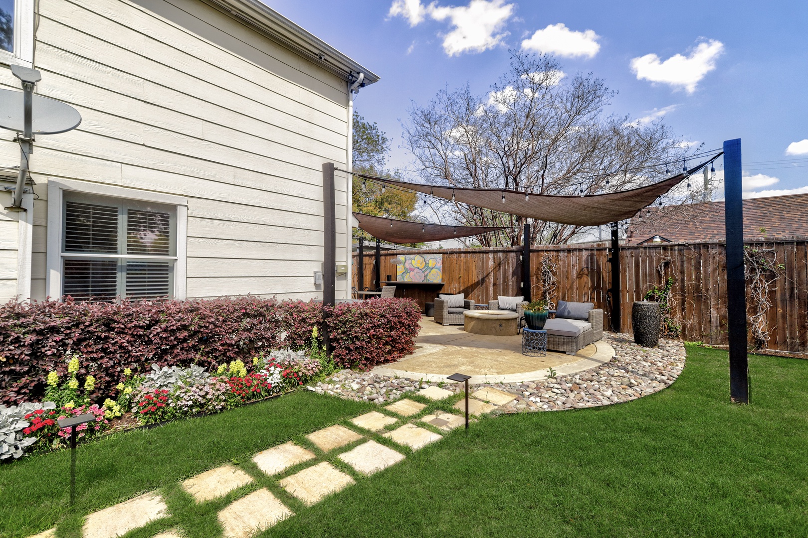 The fenced back yard oasis offers loads of space for relaxation & play