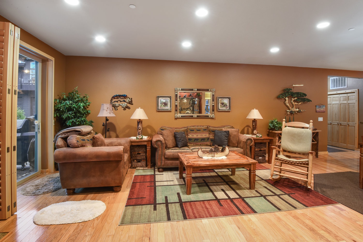 Open living space with ample seating, fireplace, Smart TV, and patio access
