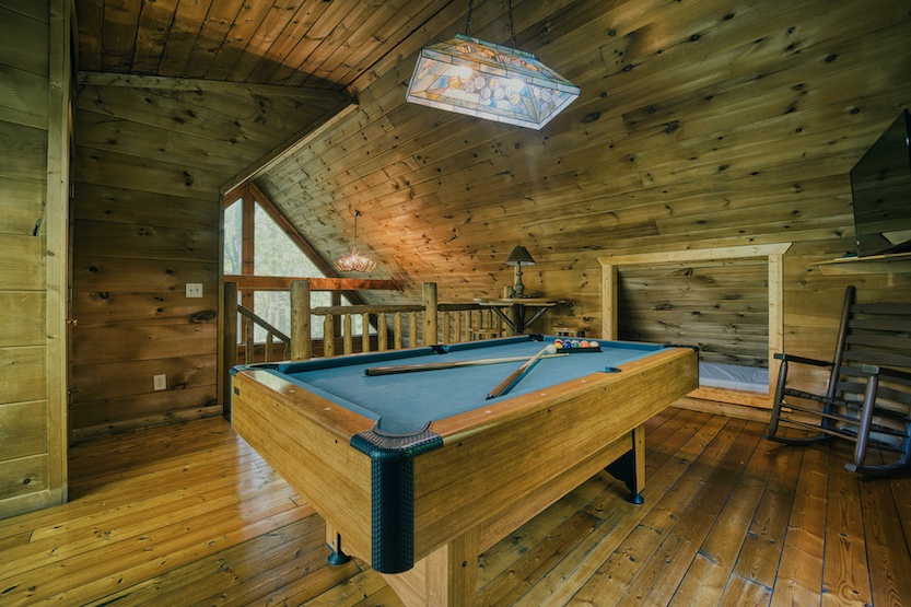 Get competitive in the loft, offering a pool table, Smart TV, & sleeping nook
