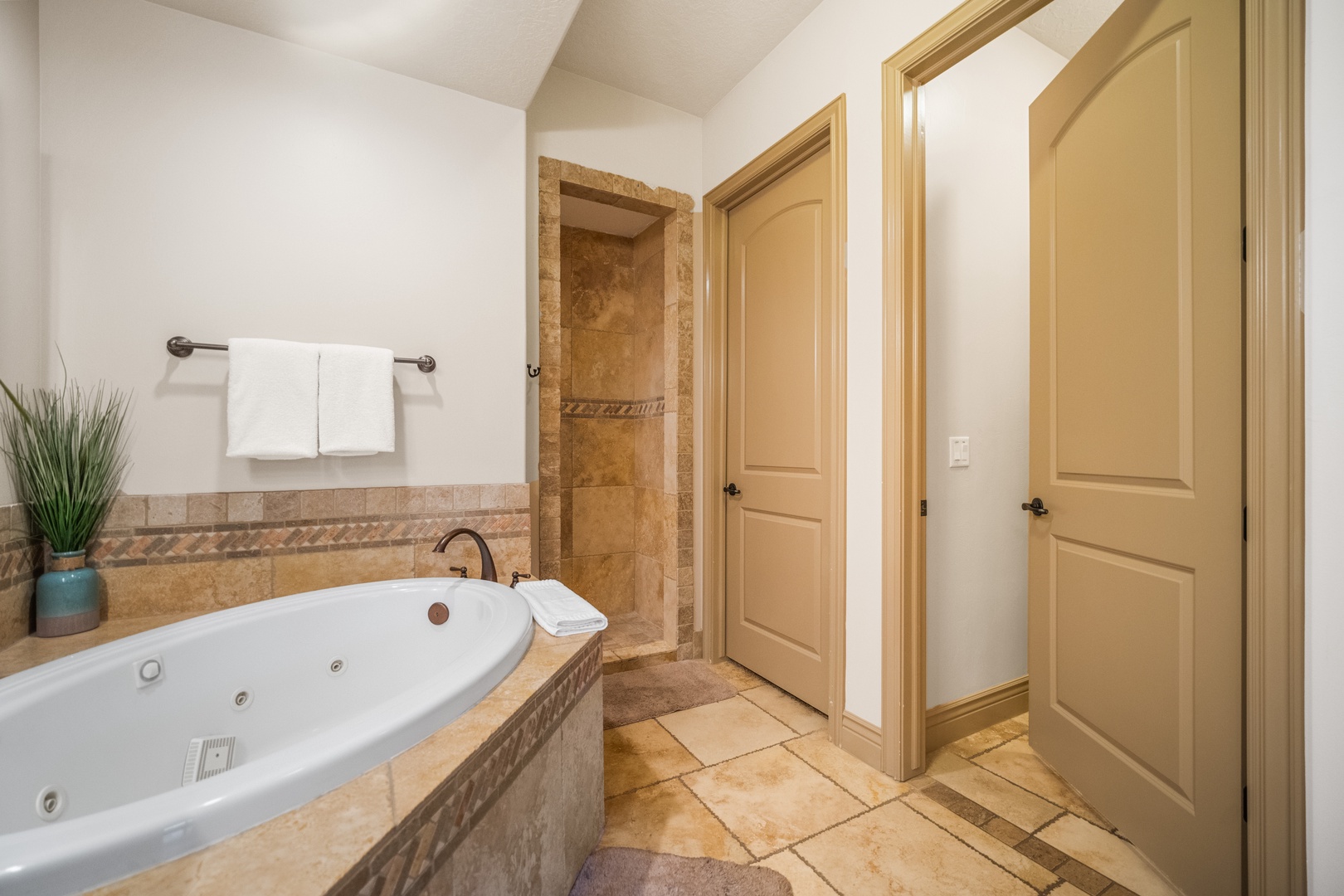 The primary ensuite showcases a dual sink, soaking tub & walk-in shower