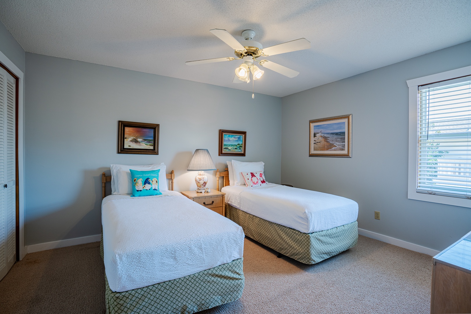 This serene double twin bed suite boasts a private ensuite with ceiling fan