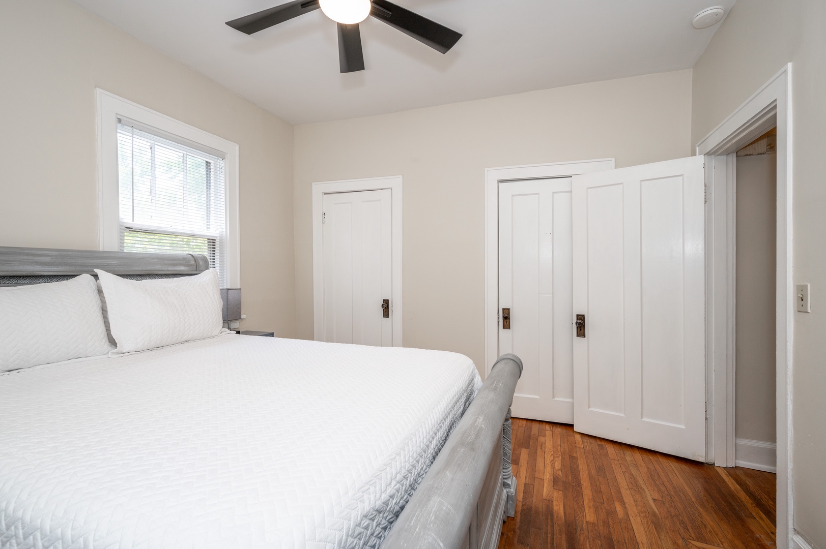 The private bedroom retreat offers a plush king-sized bed & ceiling fan