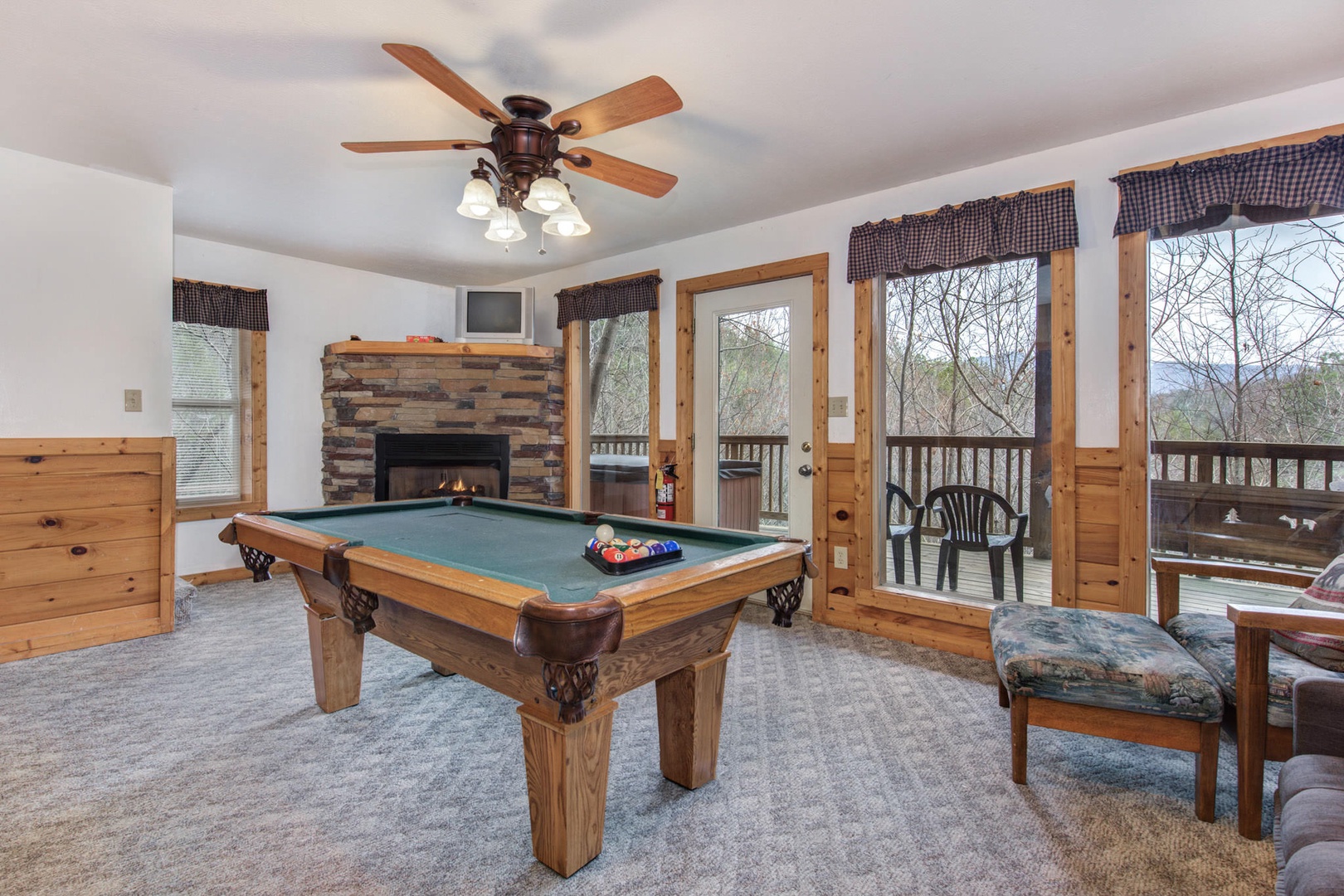Game room with pool table, fireplace, and deck (lower level)
