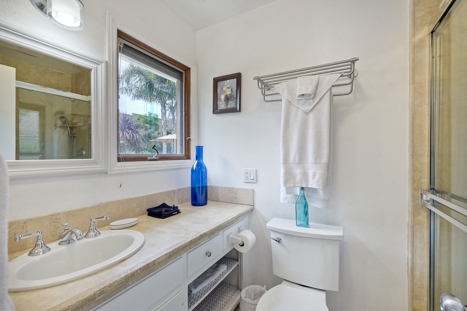 The private ensuite hosts a single vanity & glass walk-in shower