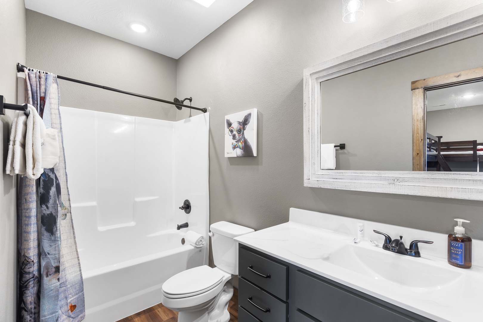 The fifth bedroom’s ensuite includes a single vanity & shower/tub combo