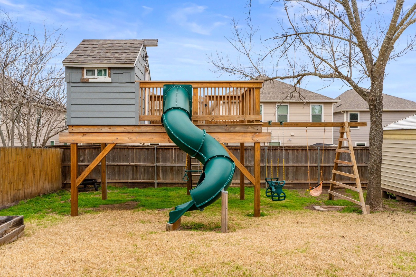 The backyard playground equipment/clubhouse is sure to be a hit with littles!