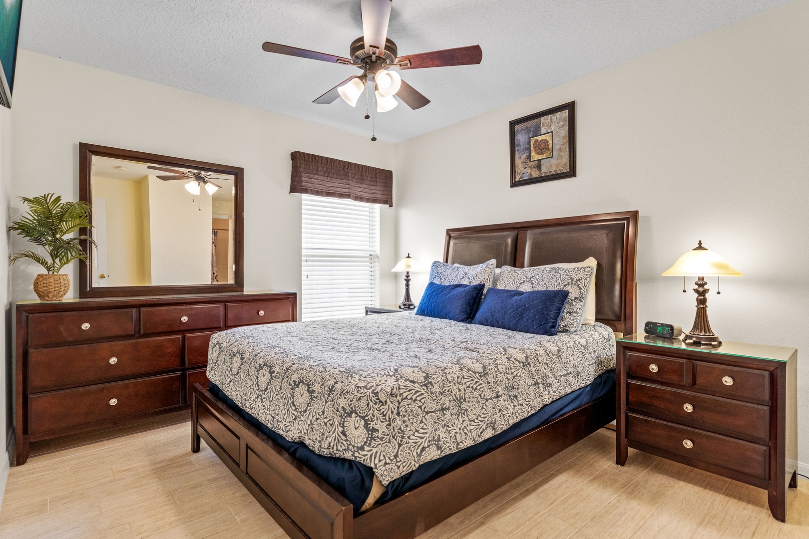 Cozy king bedroom with ceiling fan and private ensuite