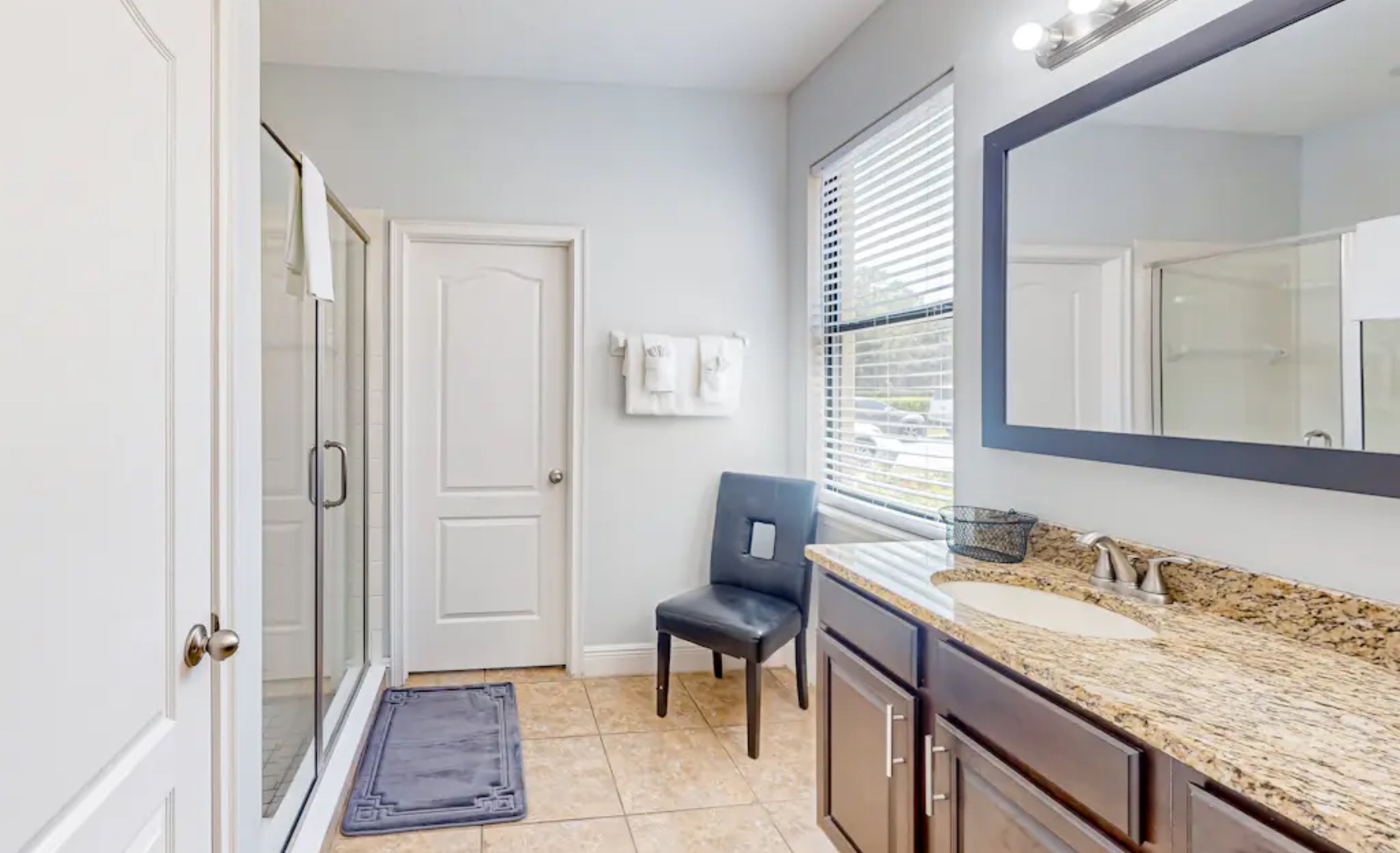 A double vanity & glass shower await in this 1st-floor ensuite