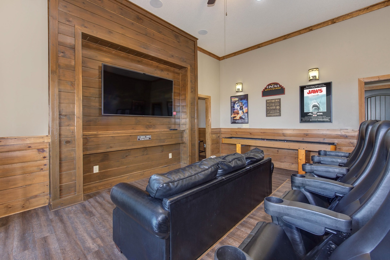 Movie & shuffleboard lovers are sure to love the downstairs theater room!