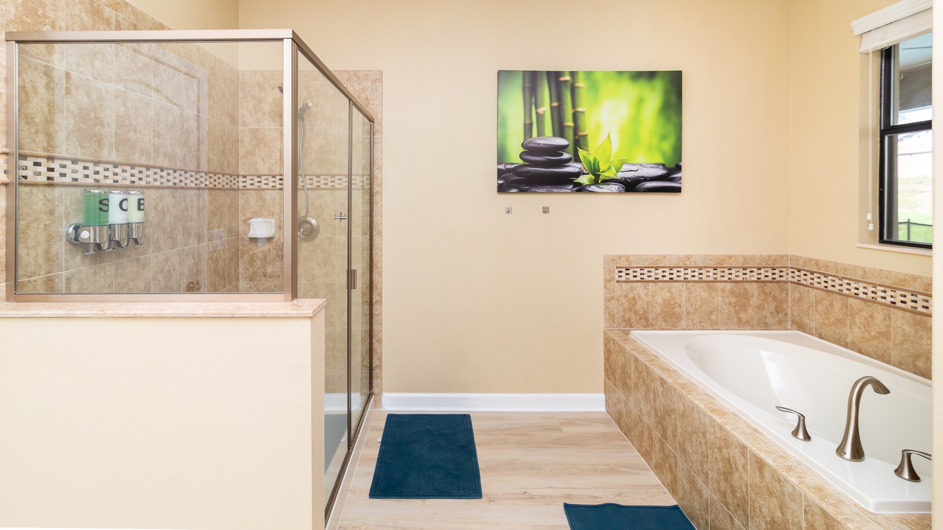 This ensuite bath features a double vanity, glass shower, & soaking tub