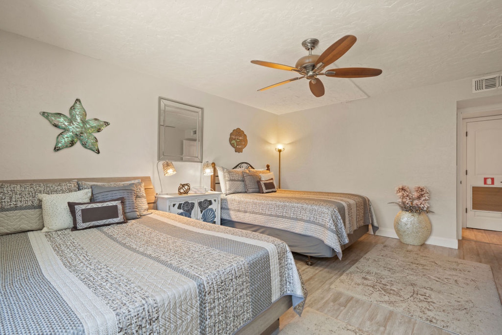 Spacious double queen bedroom with ceiling fan for added comfort
