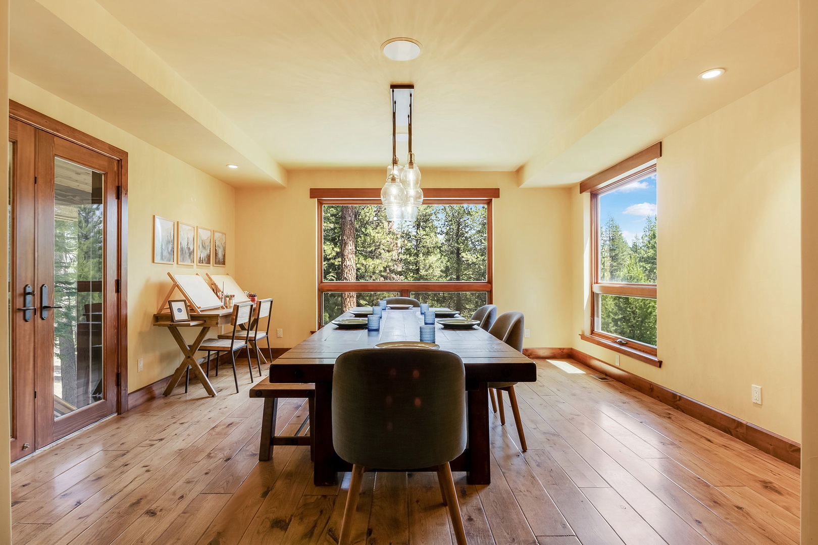 Dining area with multiple tables with seating, and paint station