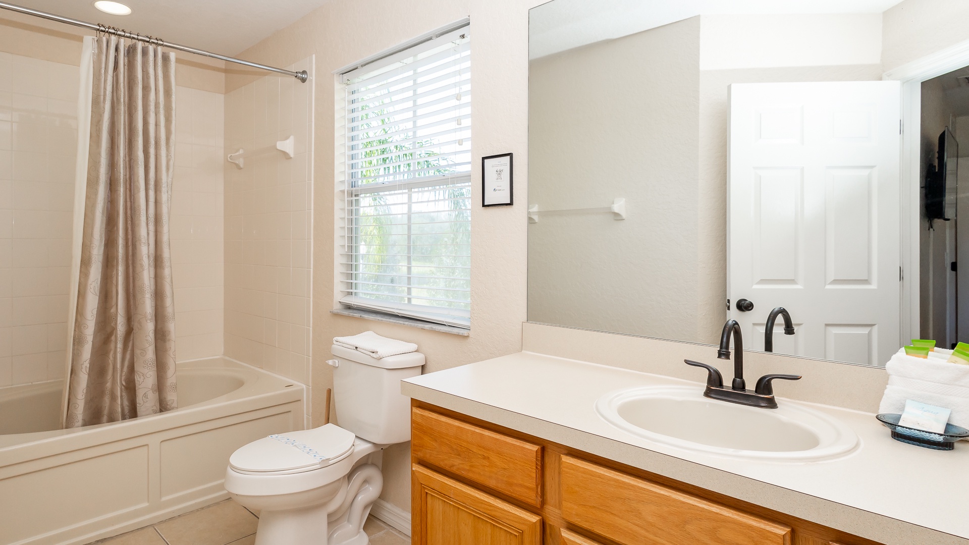 The king en suite bathroom includes a single vanity & shower/tub combo