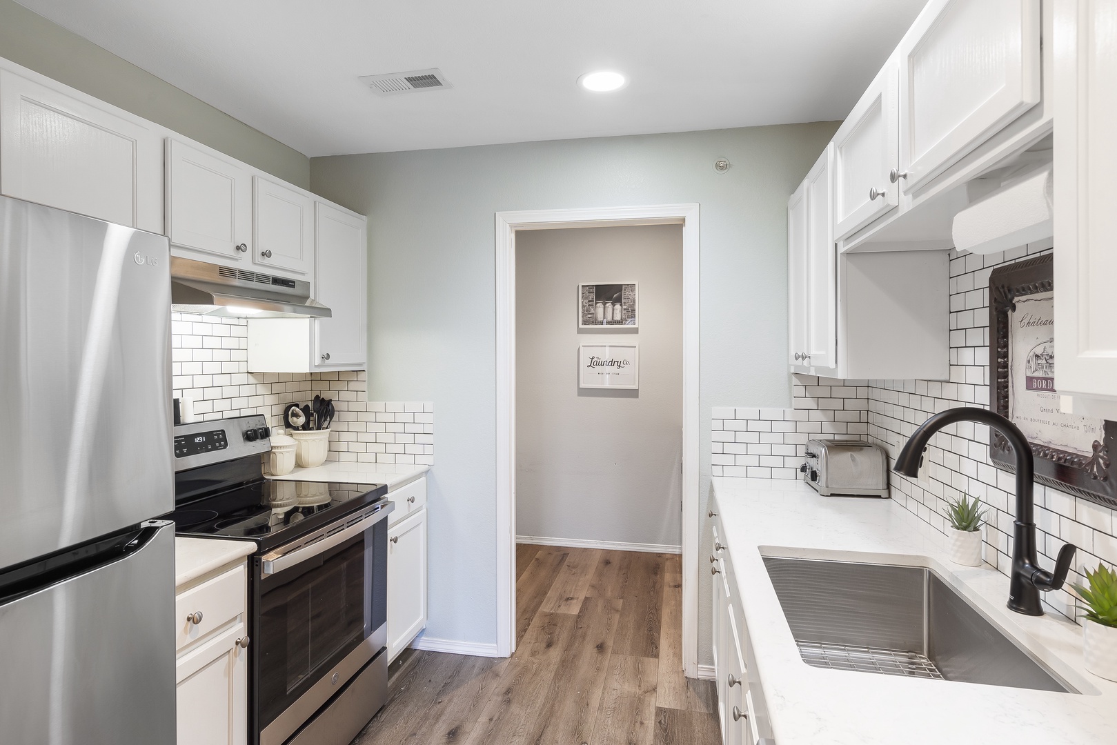 The airy kitchen offers ample space & all the comforts of home