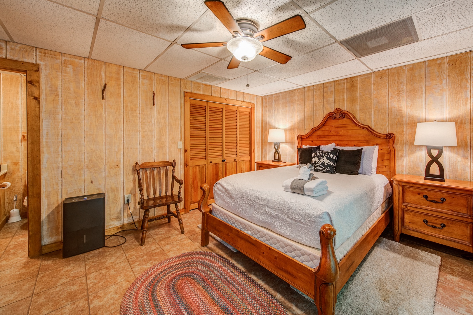 The lower-level bedroom offers a queen bed & attached en suite