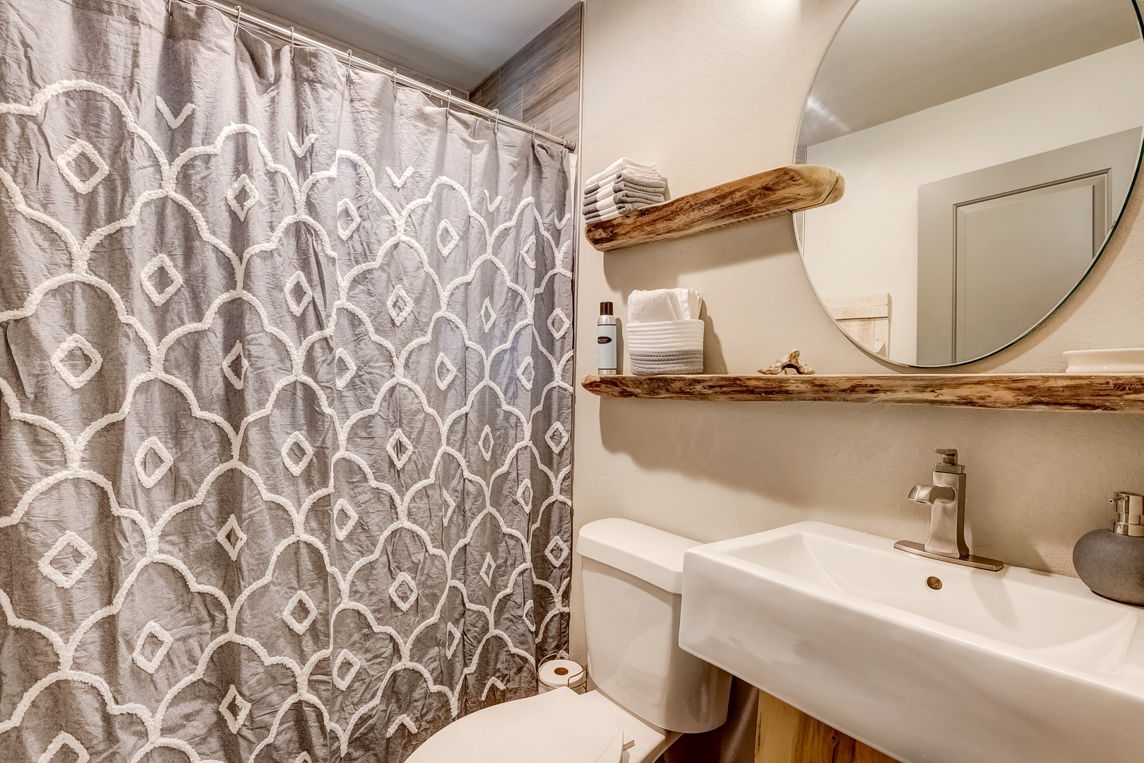 The main-level full bathroom includes a single vanity & shower/tub combo