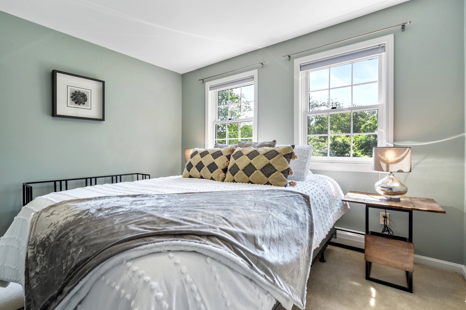 This bedroom retreat offers a cozy queen size bed and TV