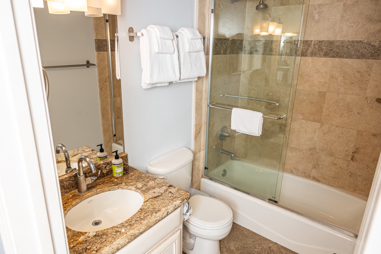 Wash up in the king ensuite, featuring a single vanity & shower/tub combo