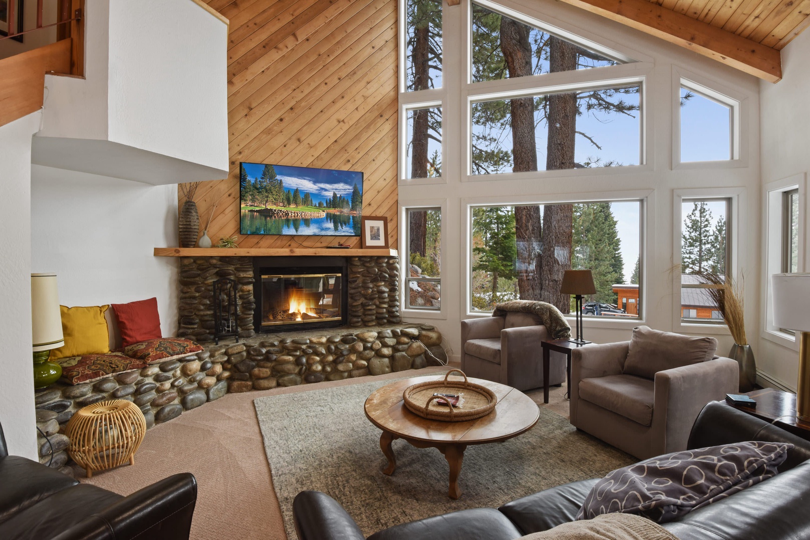 Living room w/ Smart TV, DVD player, wood burning fireplace and deck access
