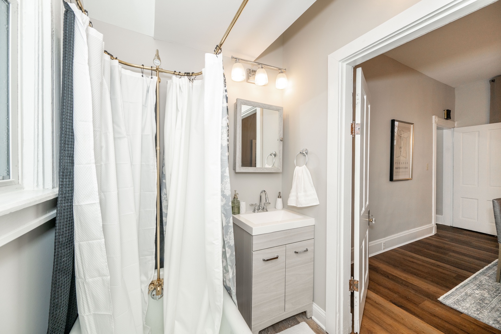 The 1st floor full bath includes a single vanity & shower/claw foot tub combo