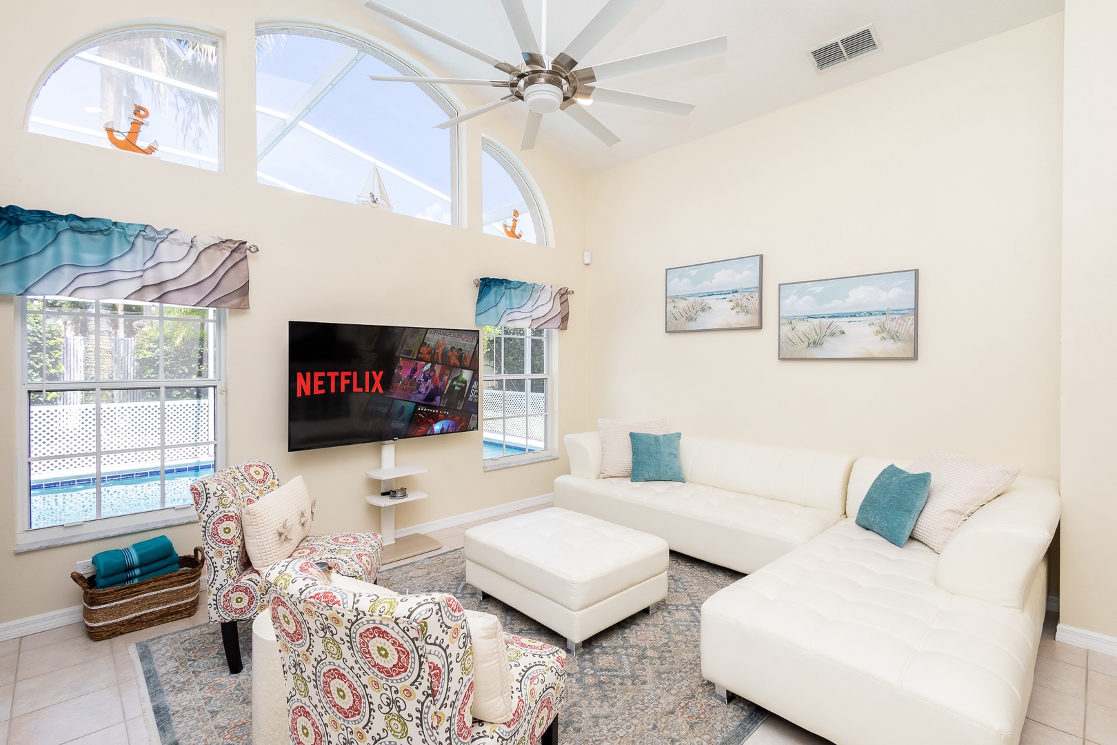 Cozy and spacious living area with, ceiling fan & smart TV