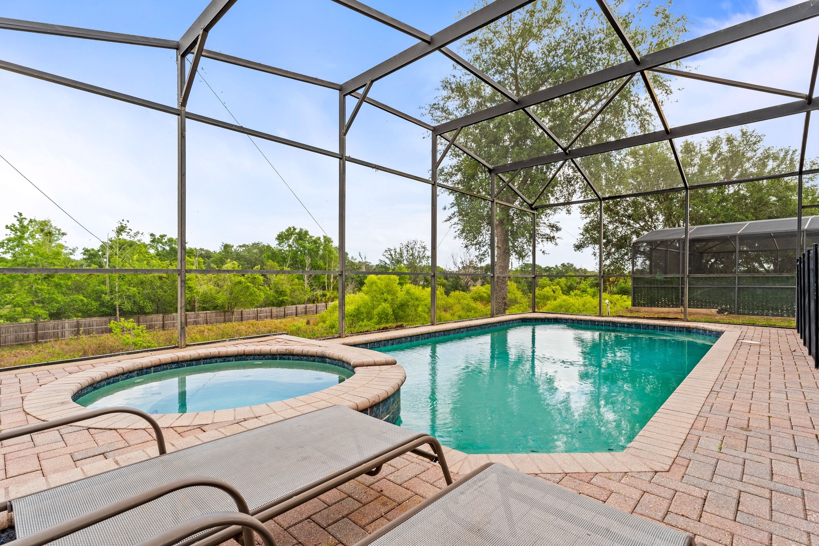 Private screened pool with outdoor seating. Note: not a hot tub just seating area.