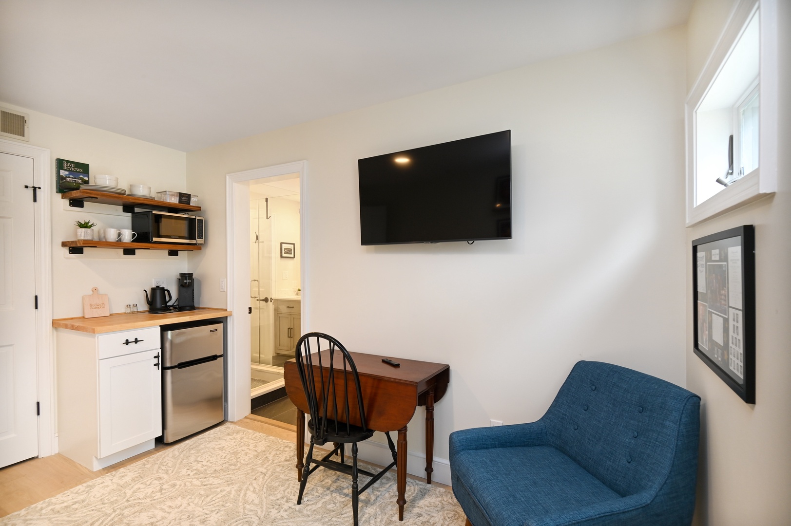 A twin daybed with twin trundle, Smart TV, & kitchenette await in this serene bedroom