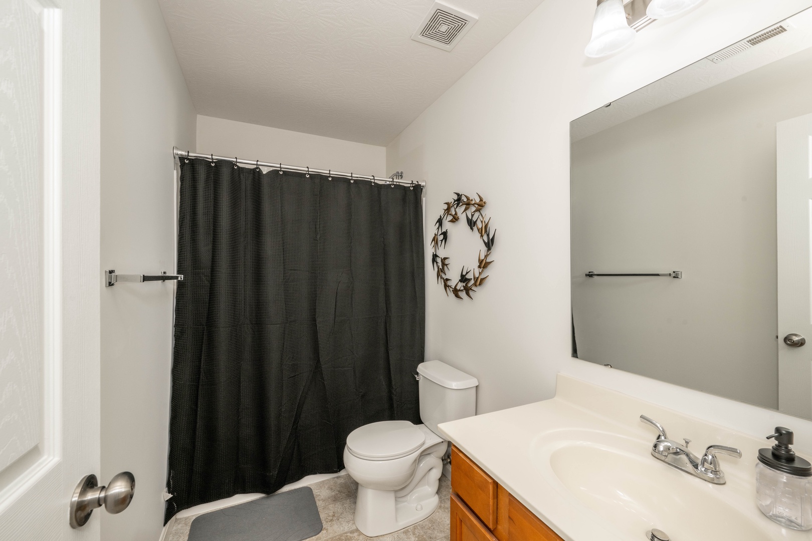 A single vanity & shower/tub combo are available in this 2nd-floor full bath