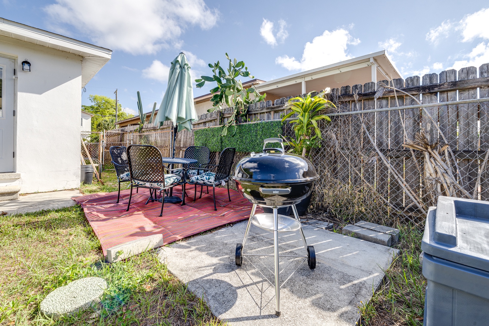 Spacious back yard with outdoor seating and grill