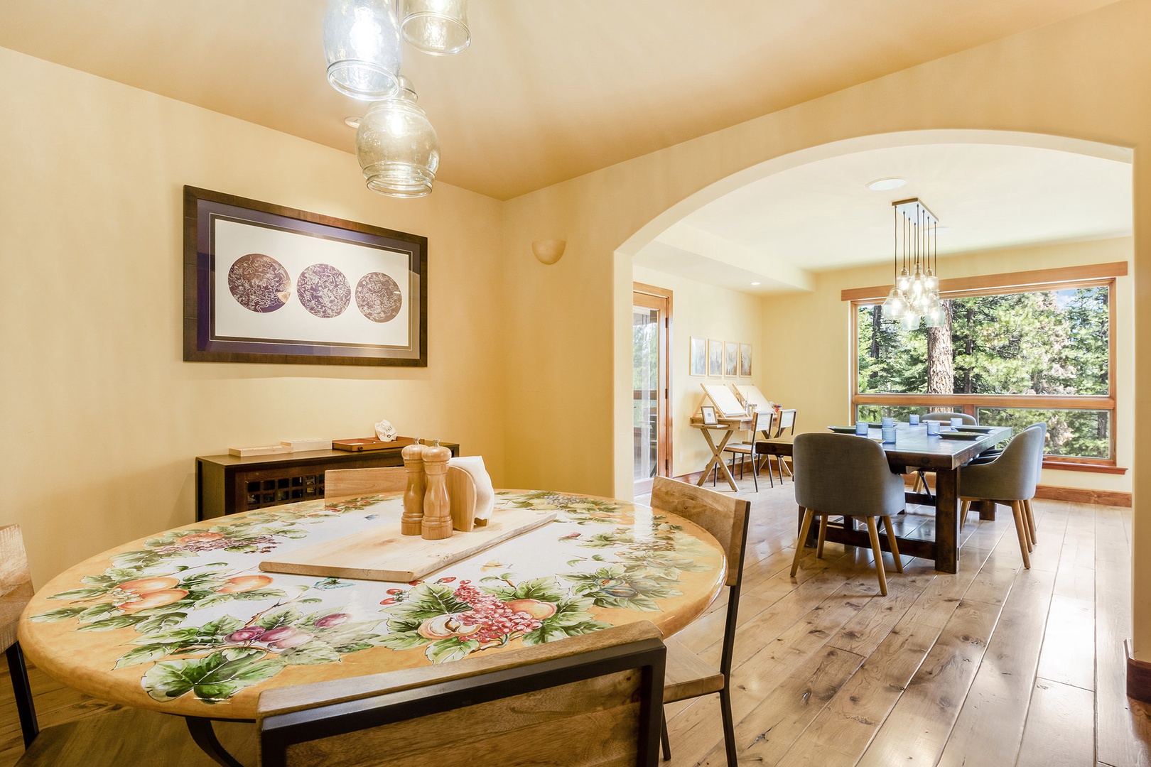 Dining area with multiple tables with seating, and paint station