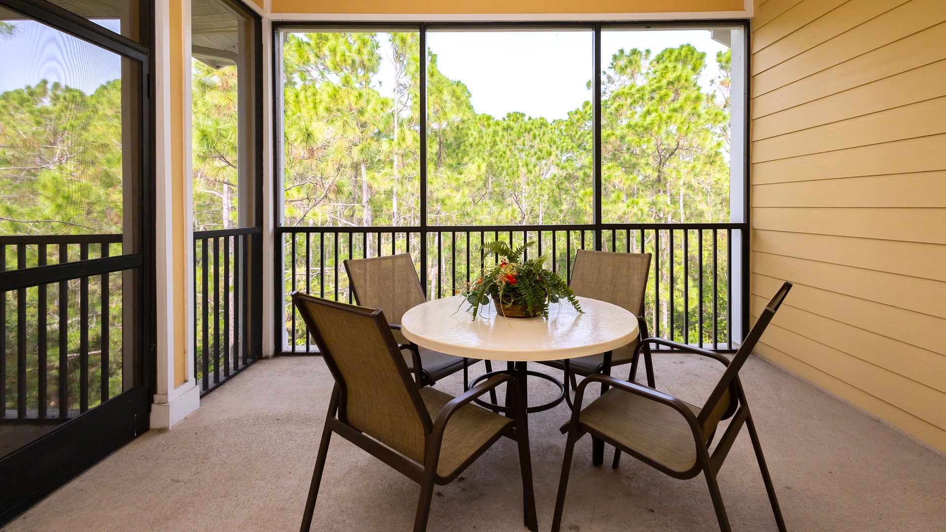 Dine alfresco on the screened-in balcony, offering space for 4